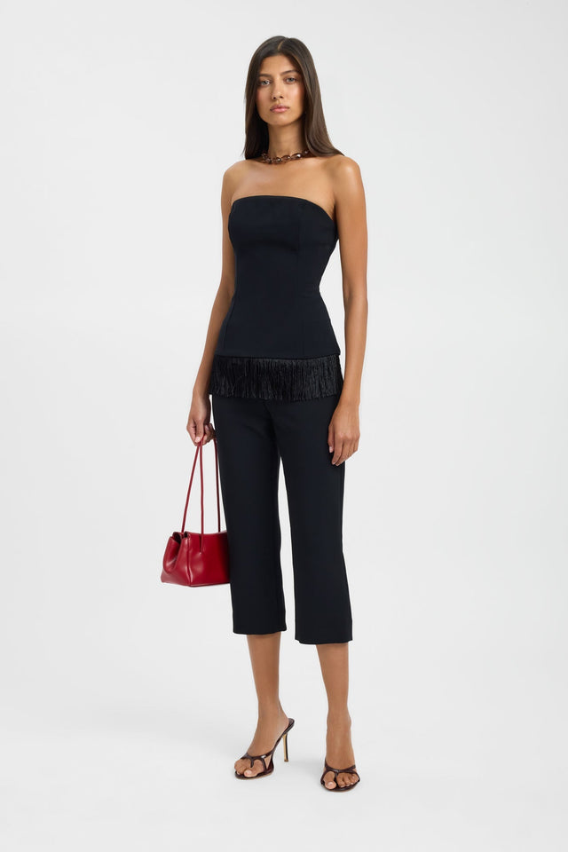 Crafted with elegance the Alto Fringe Top womens blouse in black featuring fitted silhouette, straight neckline and sleeveless design side