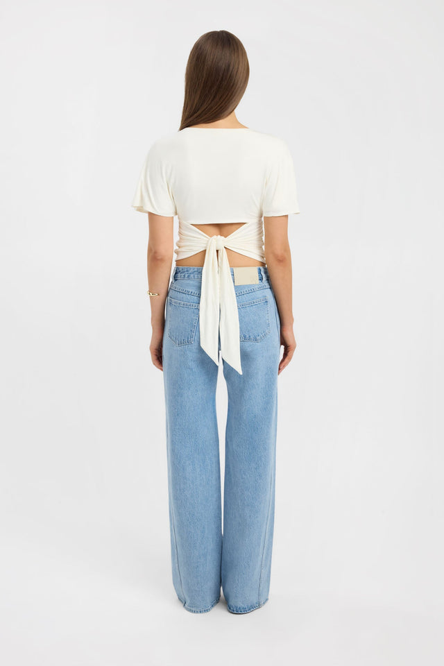 Highlighting the Isla Top womens blouse in ivory with fitted v-neckline and short sleeves detail