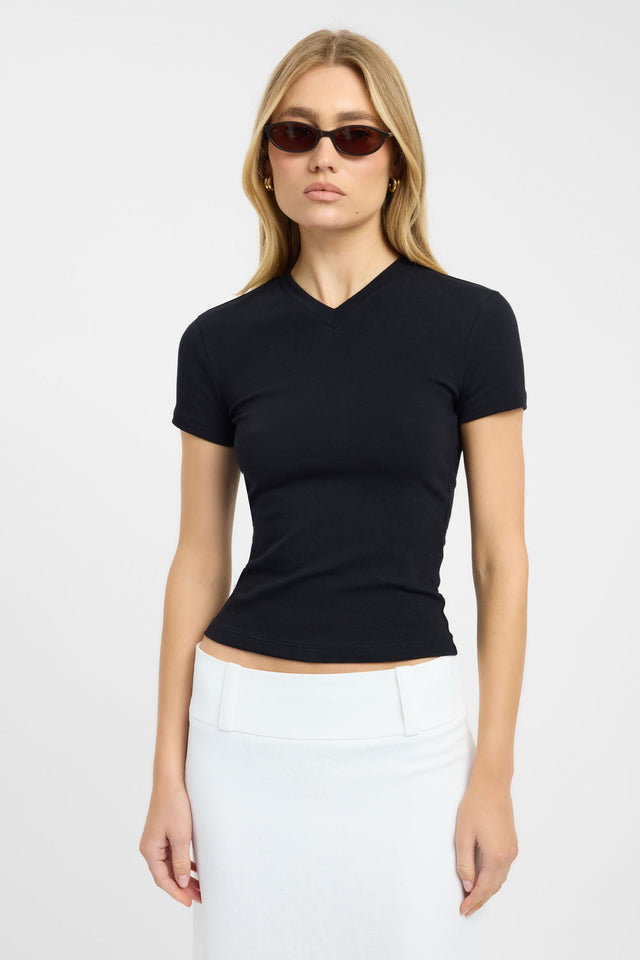 Showcasing the Jess Tee womens blouse in fitted black with v-neck and short sleeves side