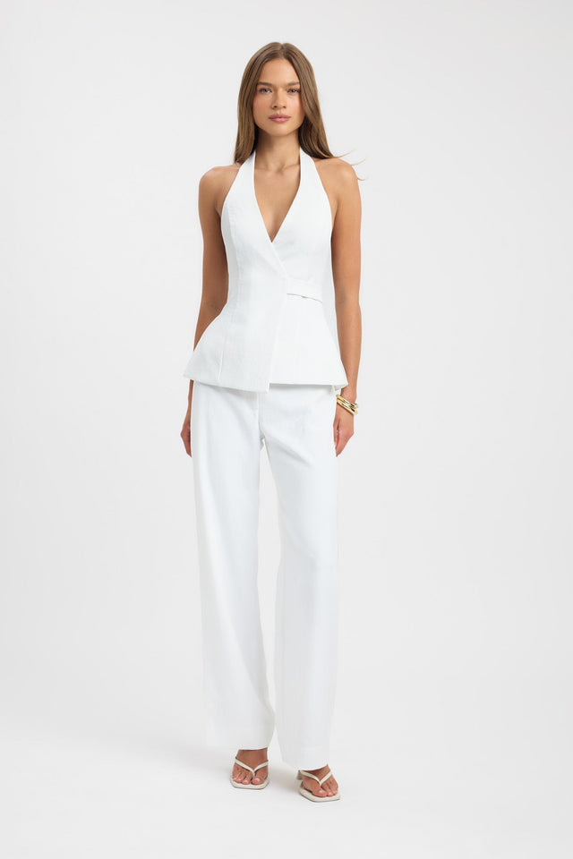 Showcasing the Ariel Wrap Top womens blouse in white with fitted v-neck sleeveless design front
