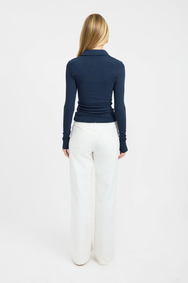 Crafted with the Myles Polo Long Sleeve Top womens blouse in navy featuring fitted silhouette and v-neck back