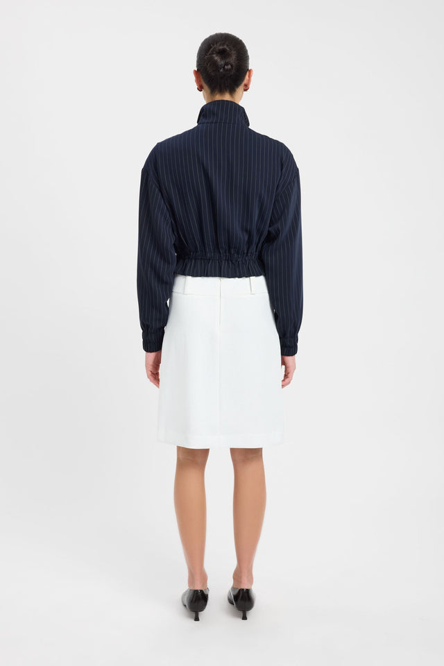 Presenting the Oslo Bomber womens coats and jackets with full sleeves in short bomber design featuring navy and white pinstripes worn with skirt side